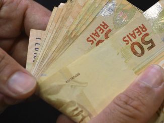 Notas e moedas de real sobre uma superfície. Foto: Agência Brasil